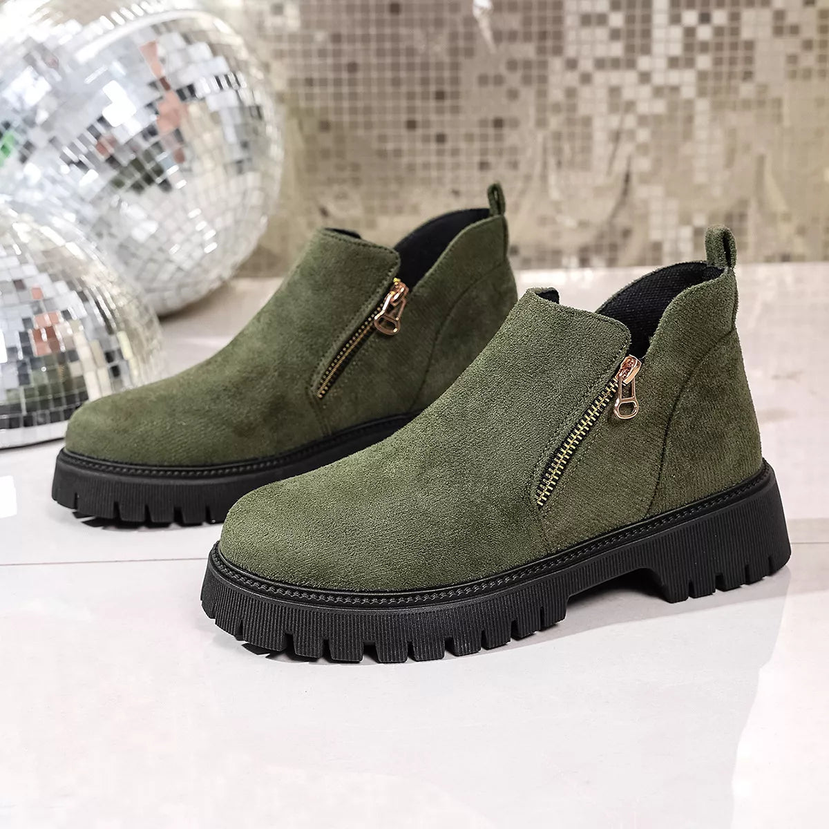 Round toe side zip ankle boots worn with cropped jeans