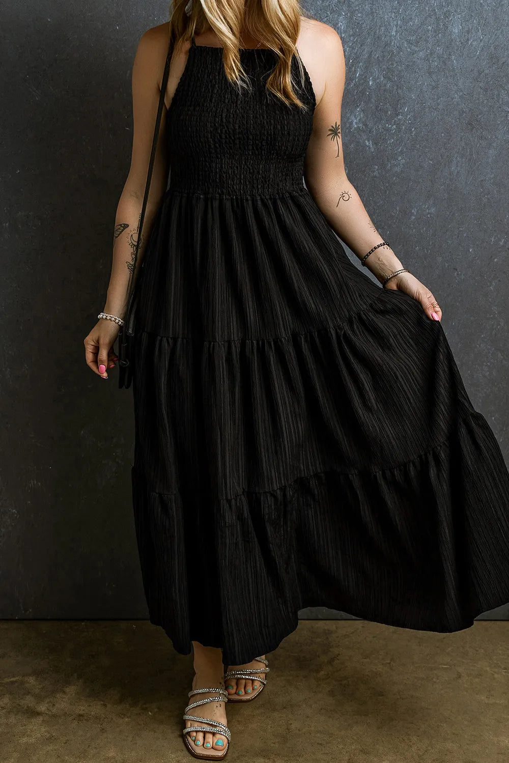 Black smocked tiered spaghetti strap maxi dress, back view