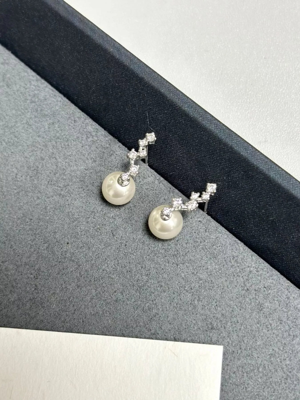 Ivory pearl and zircon sterling silver earrings detail view