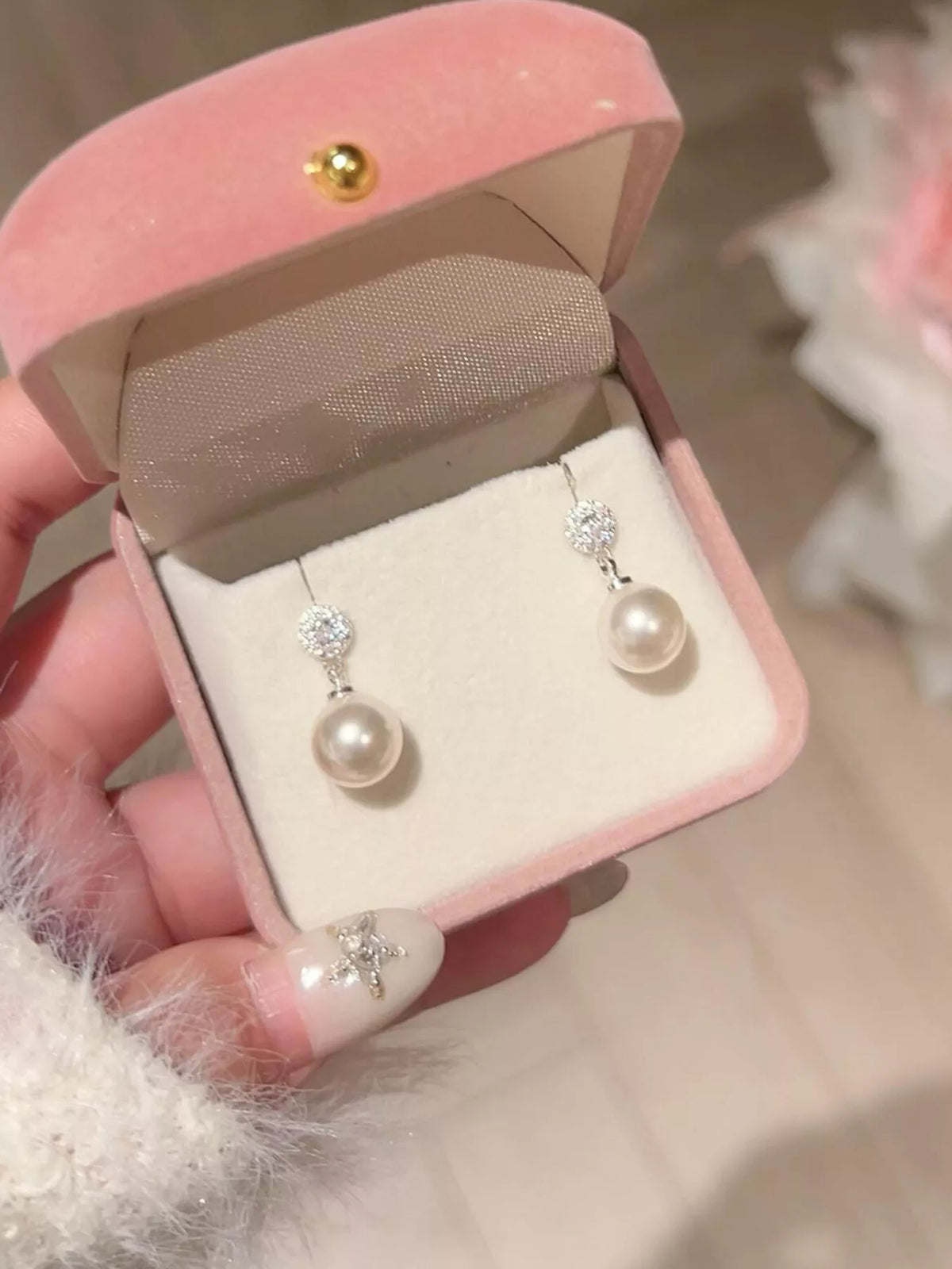 Cream pearl drop earrings close up detail