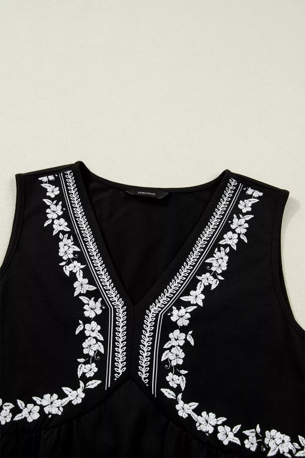 Close view of the shoulder and armhole of the sleeveless top