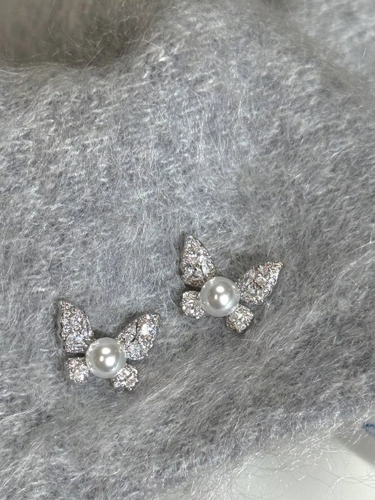 butterfly pearl stud earrings angle view