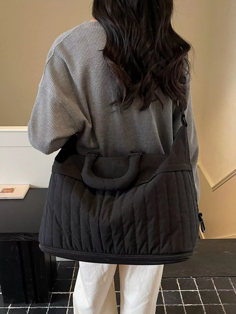 Black quilted nylon travel duffel front view