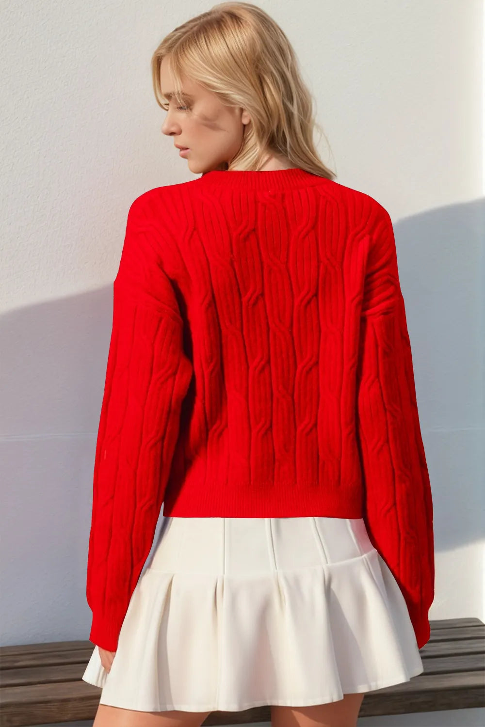 Cable knit bow sweater shown on model