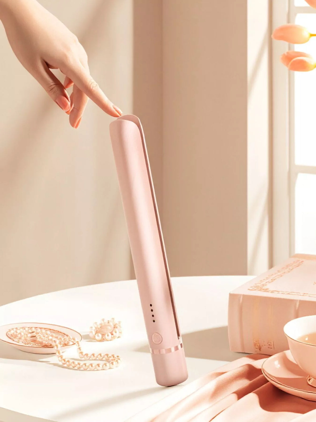 Straightener held in hand for scale