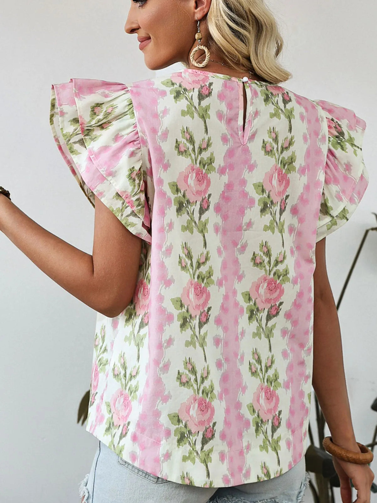 Blush pink floral blouse angled view