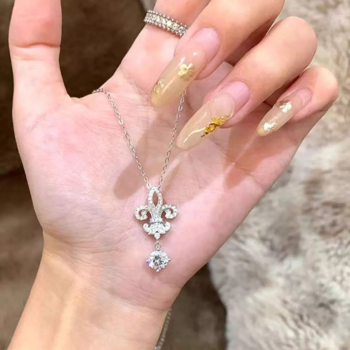 Iris pendant necklace shown worn at the collarbone
