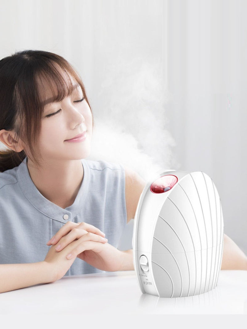 White facial steamer beauty device on a counter