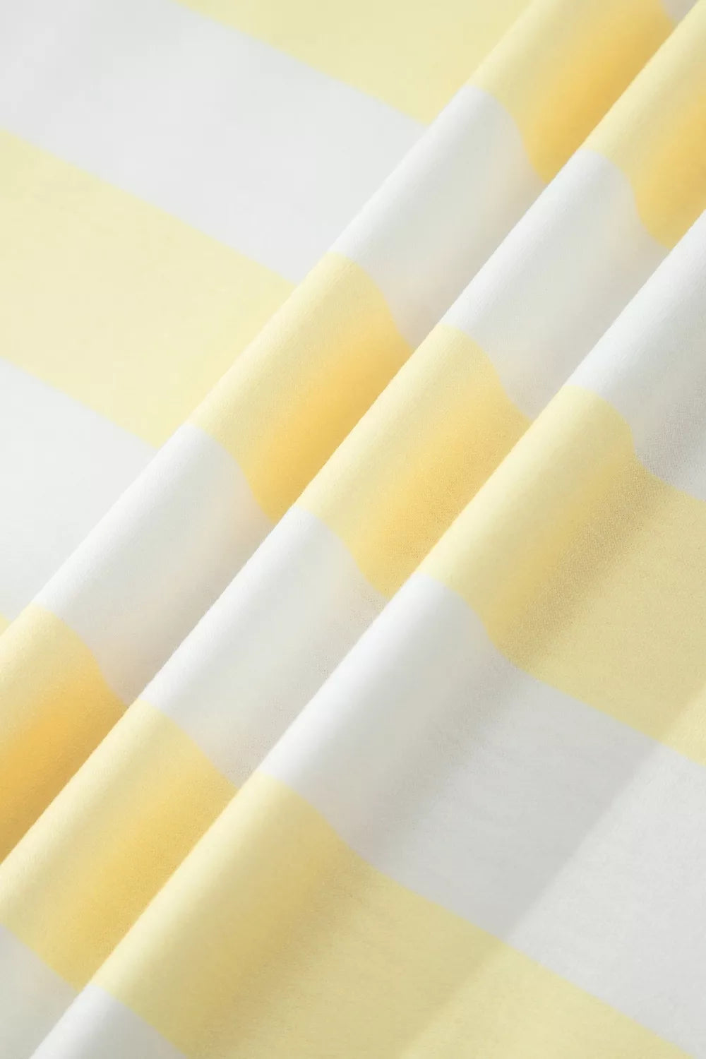 Striped half sleeve top laid flat, full garment view