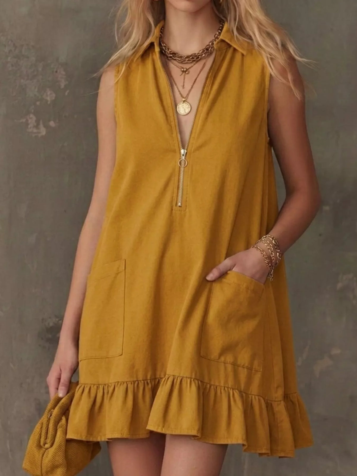 Sleeveless zip front dress ruffle hem detail