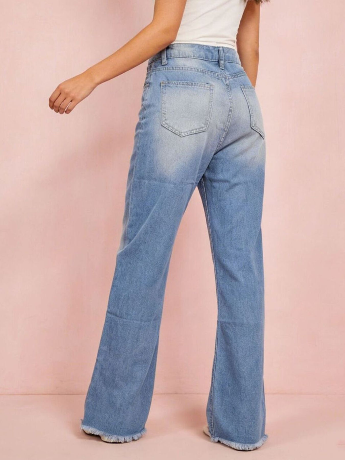 Light blue distressed bootcut jeans side view