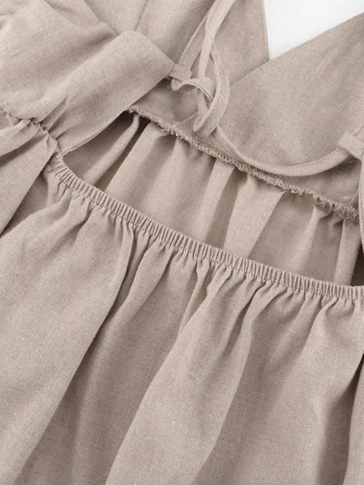 Waist and hem detail on the khaki mini dress