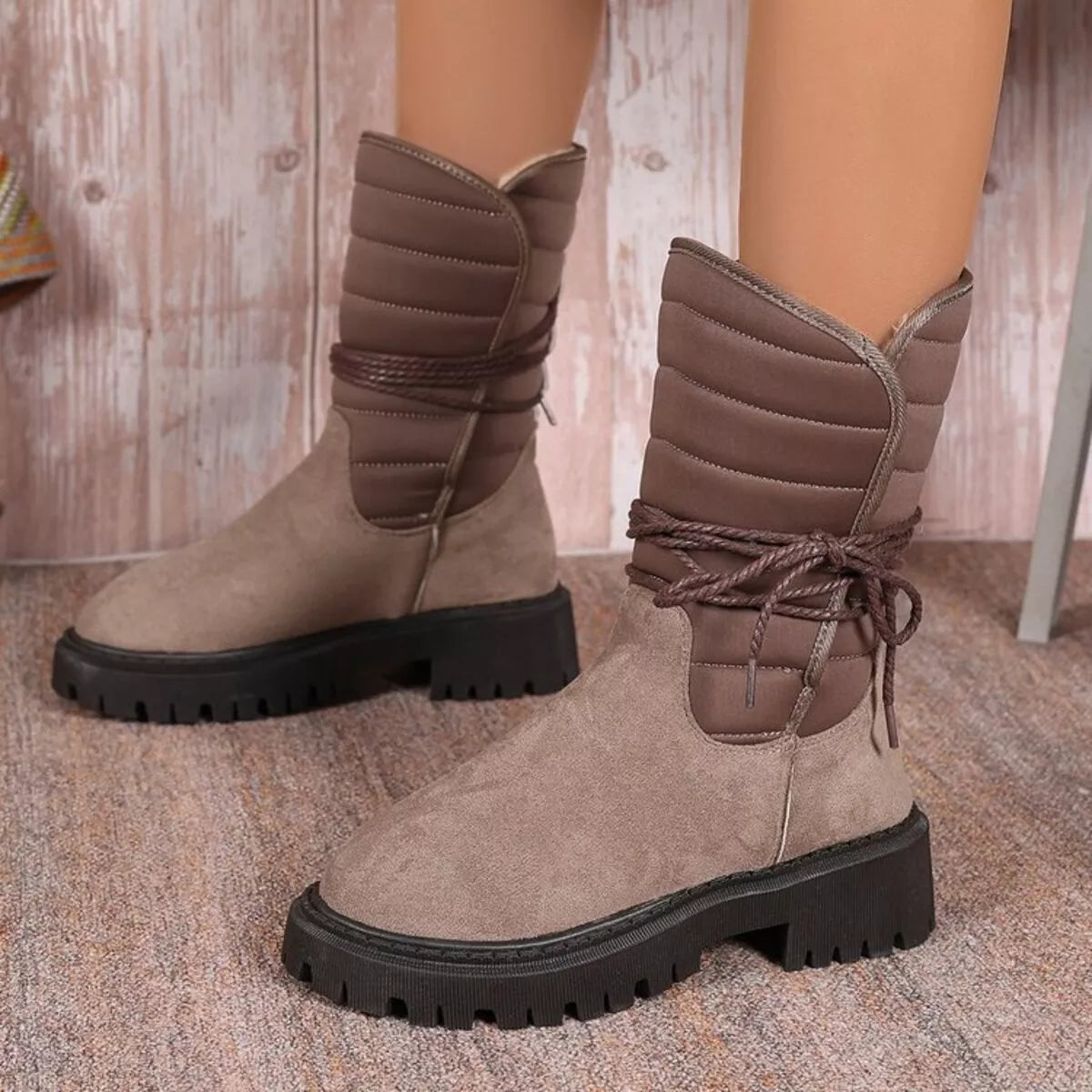 Quilted lace up mid calf boots pair standing