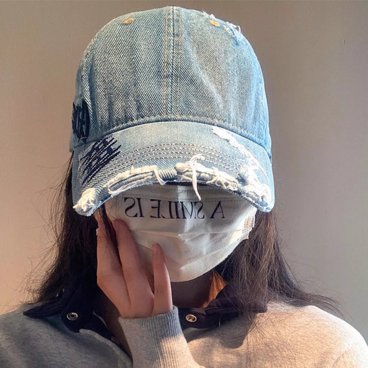 Embroidered letter detail on the distressed cotton cap