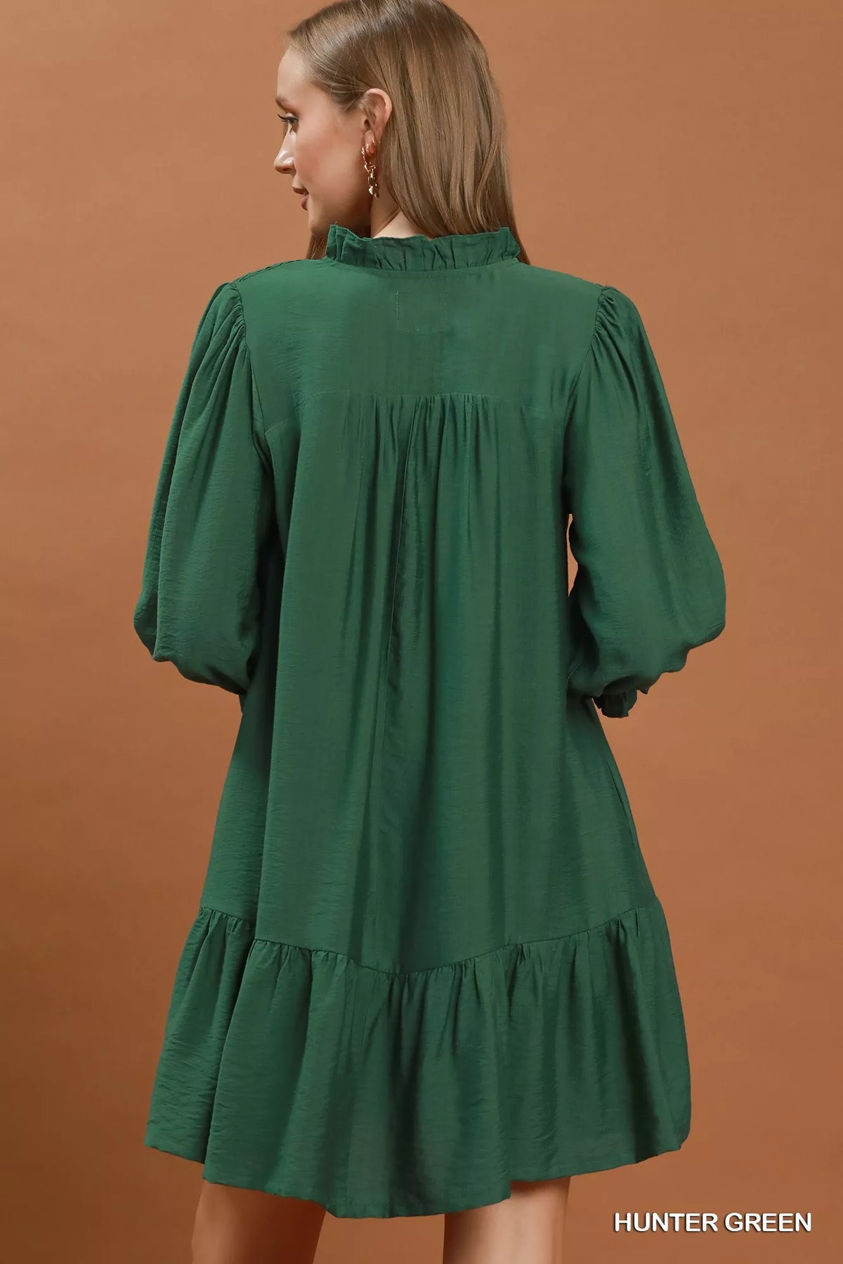 Smocked bodice and ruffle detail on the green mini dress