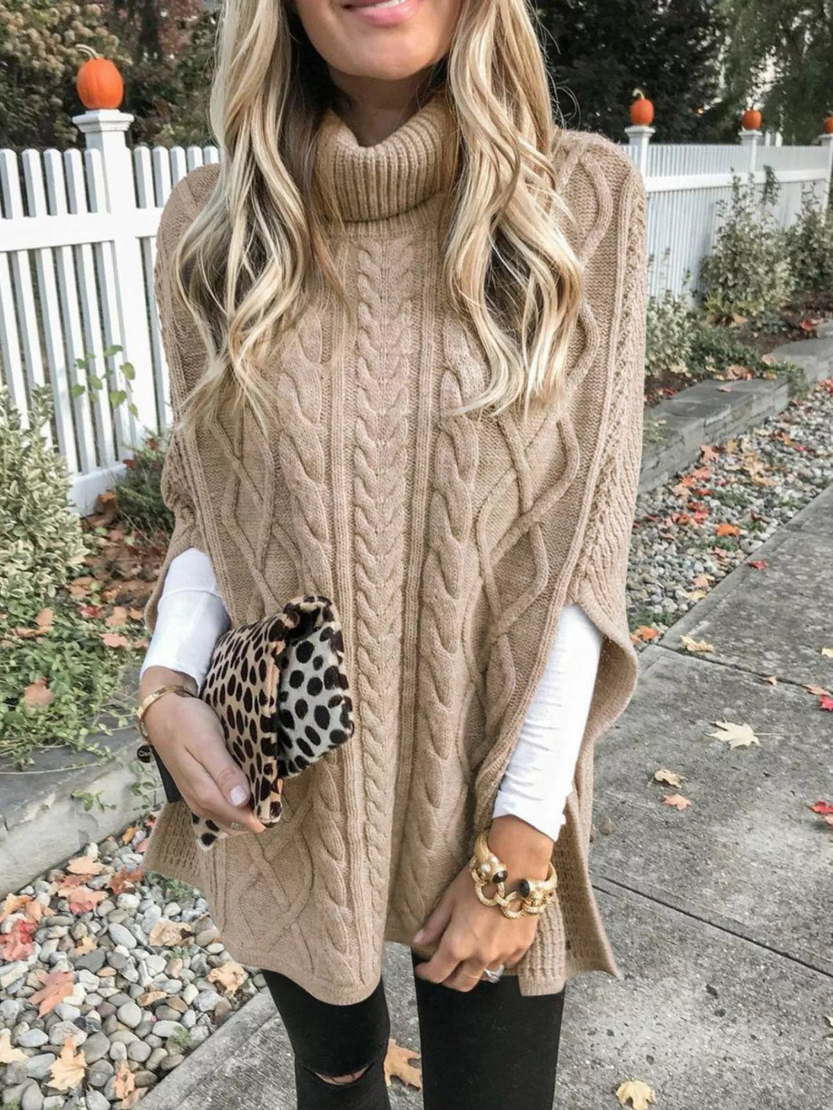 Chunky cable knit turtleneck poncho collar detail view