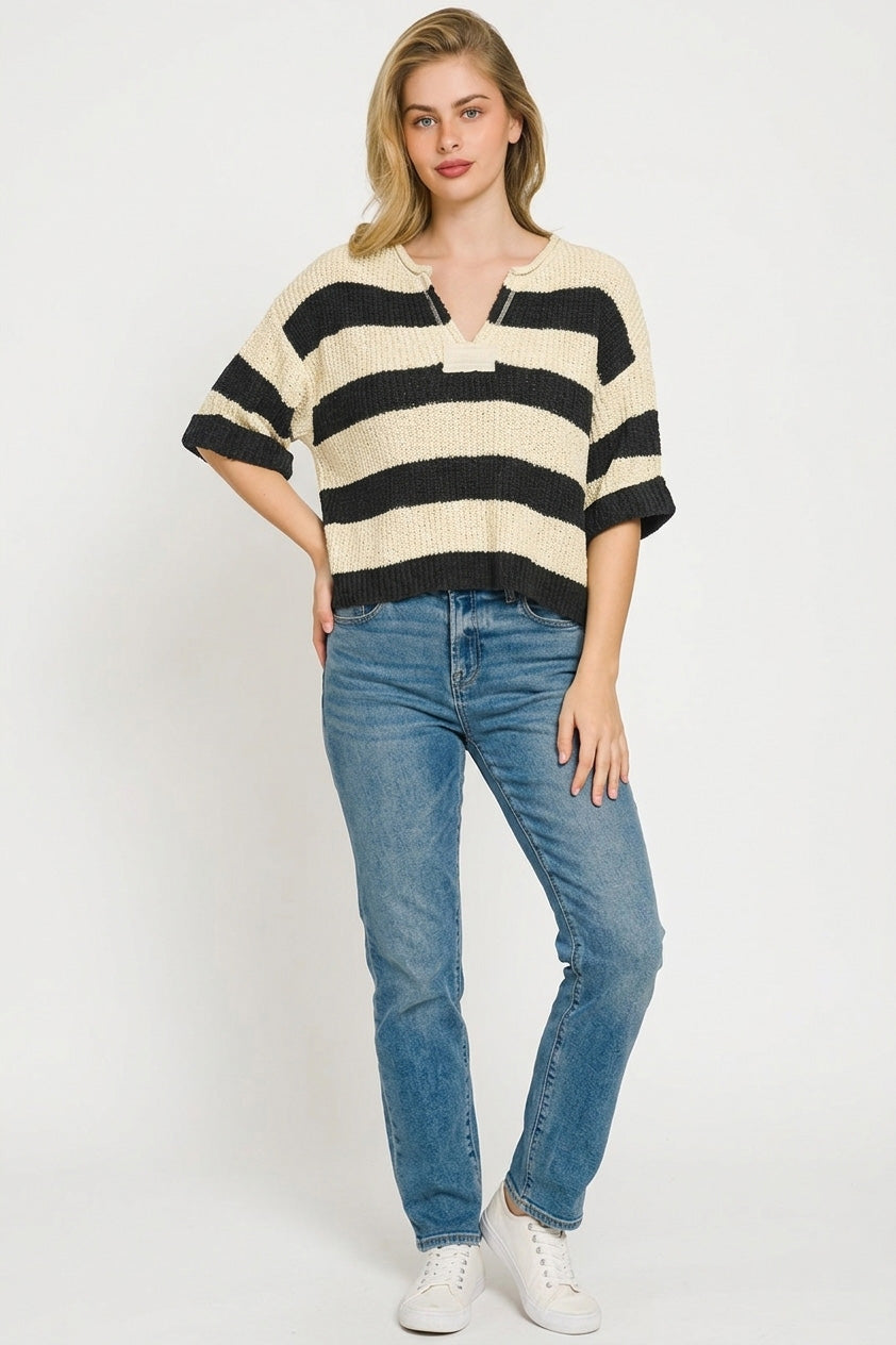 Model wearing split neck stripe sweater relaxed fit