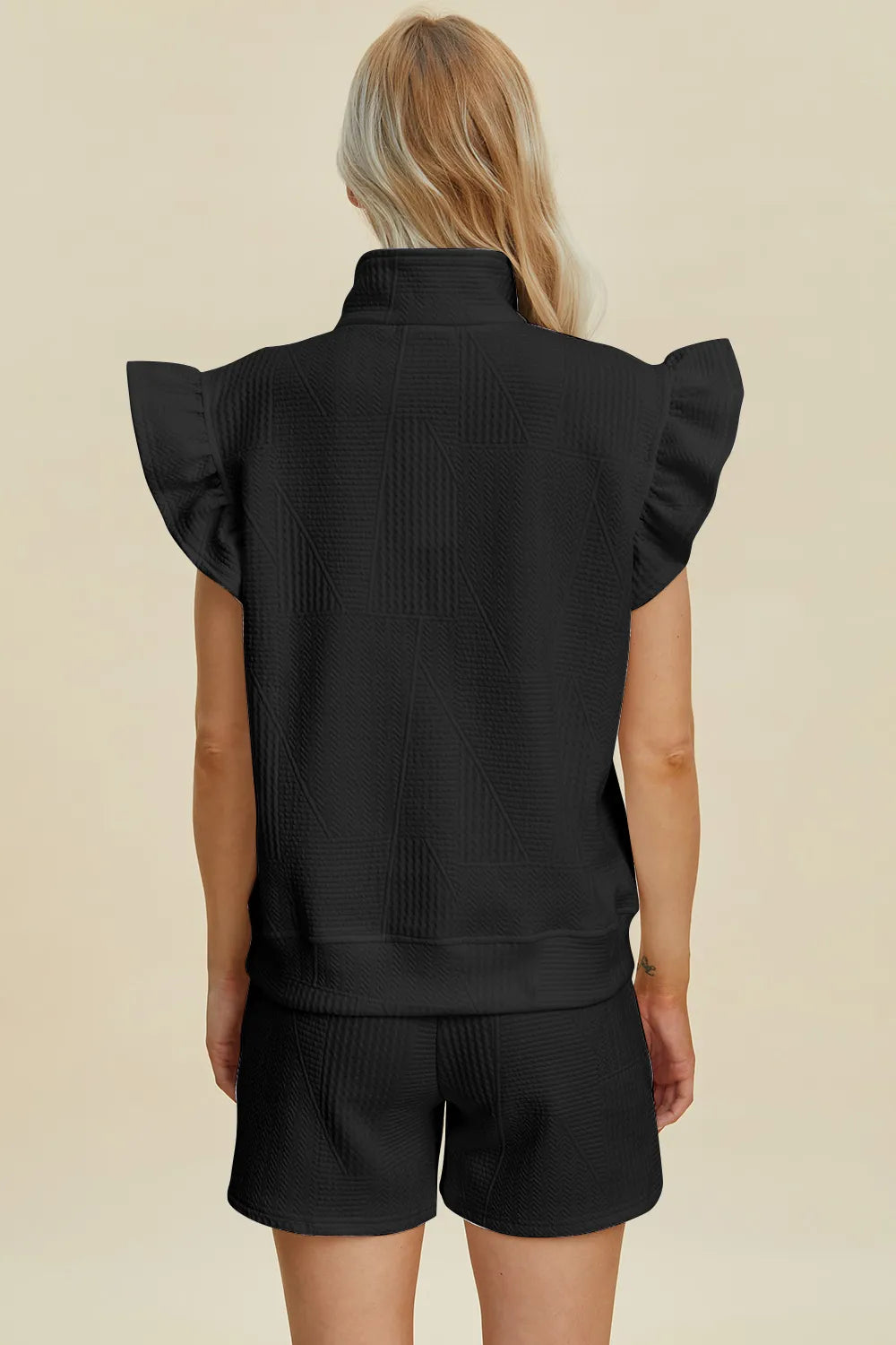 Close up of flounce sleeve and textured knit fabric