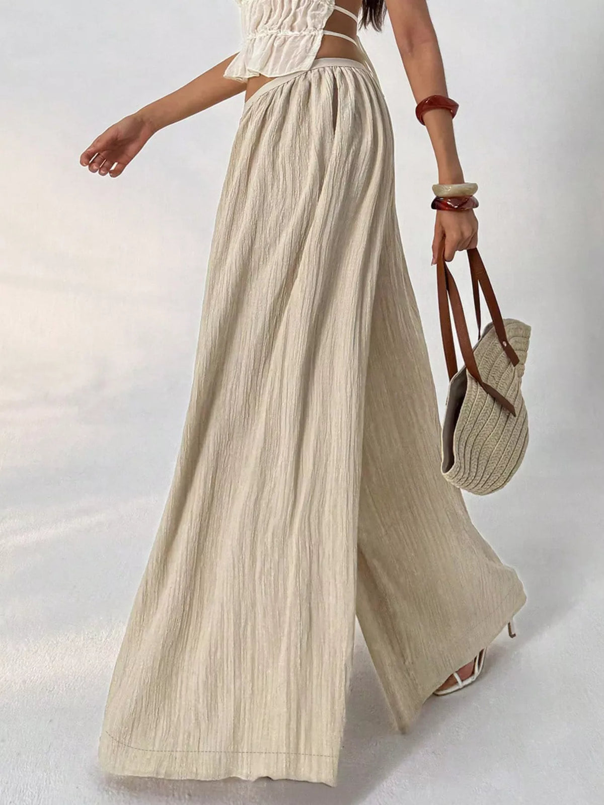 Side view showing the wide flowing leg of the khaki pants