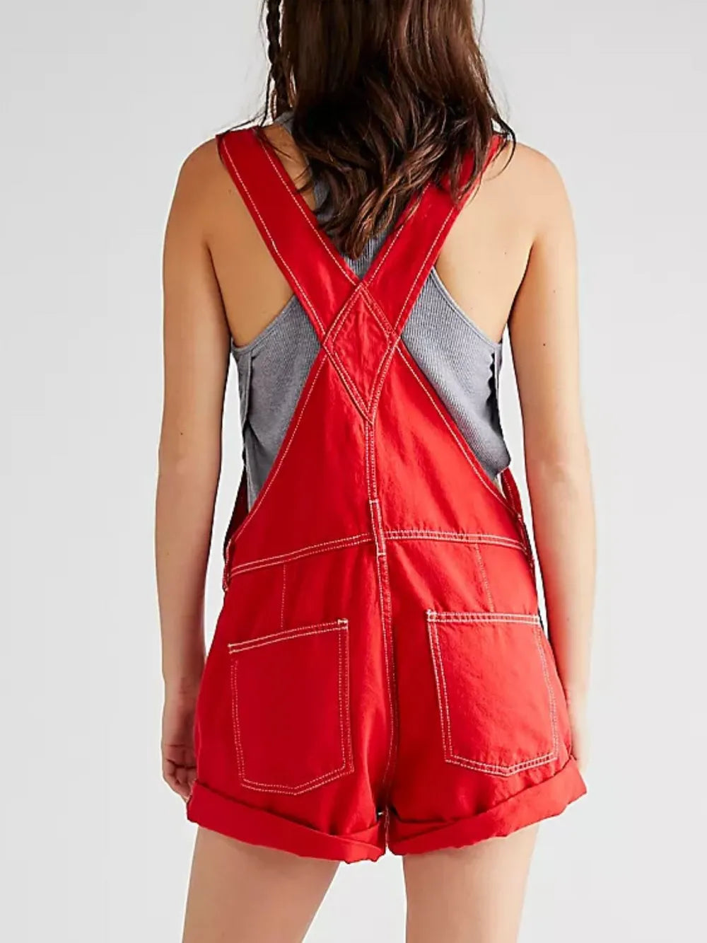 Red denim overalls side view on model