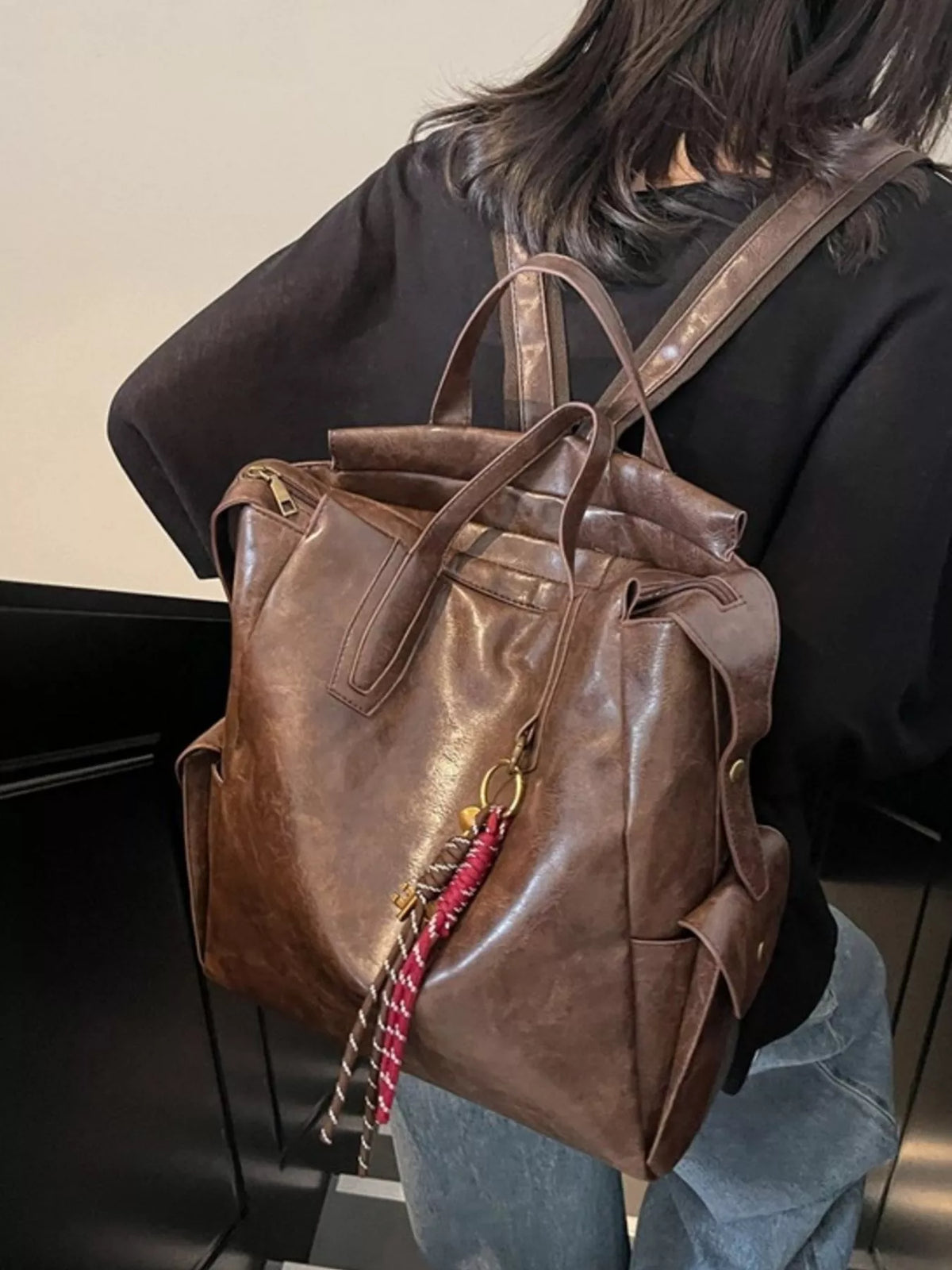 Vintage leather convertible backpack handle detail
