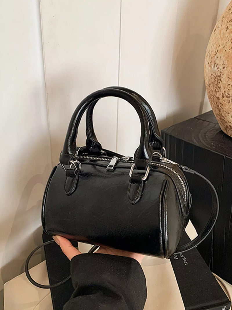 Black cylinder PU leather shoulder bag front view