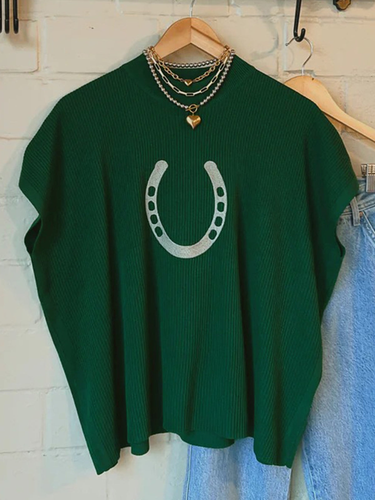 Dark green short sleeve graphic sweater styled on model