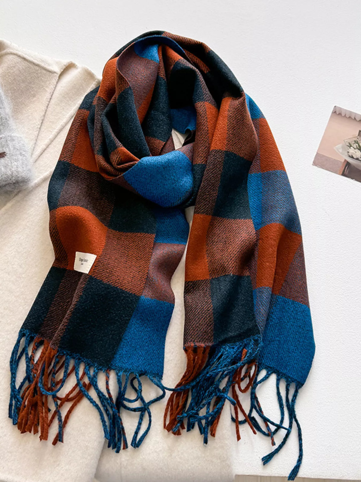 Plaid blanket scarf shown folded