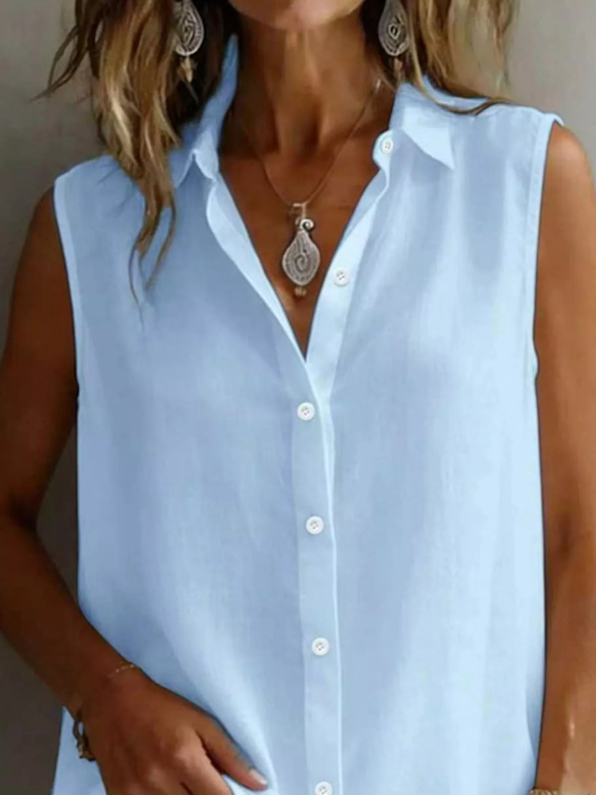 Sleeveless collared button down shirt full length view