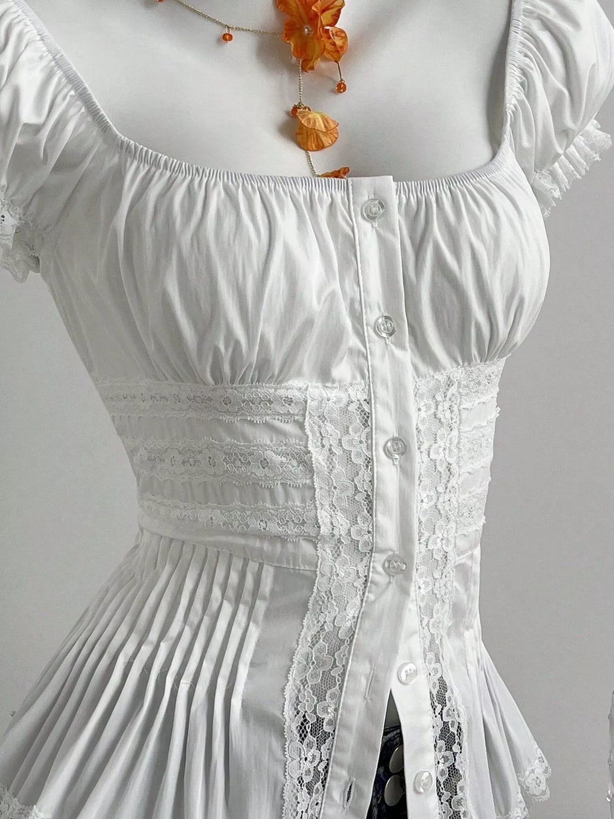 Cropped lace shirt shown from the side