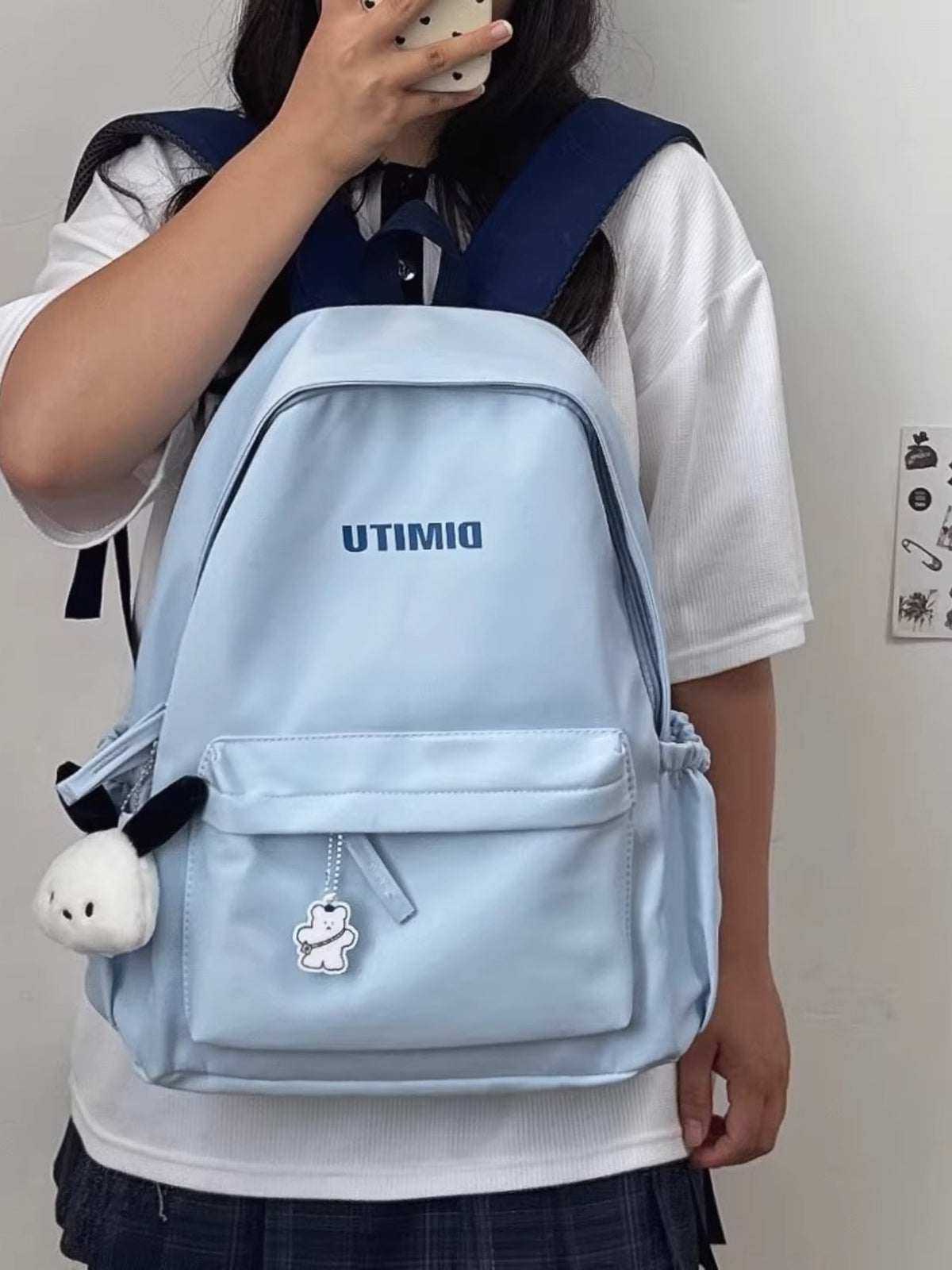 light blue nylon backpack back view