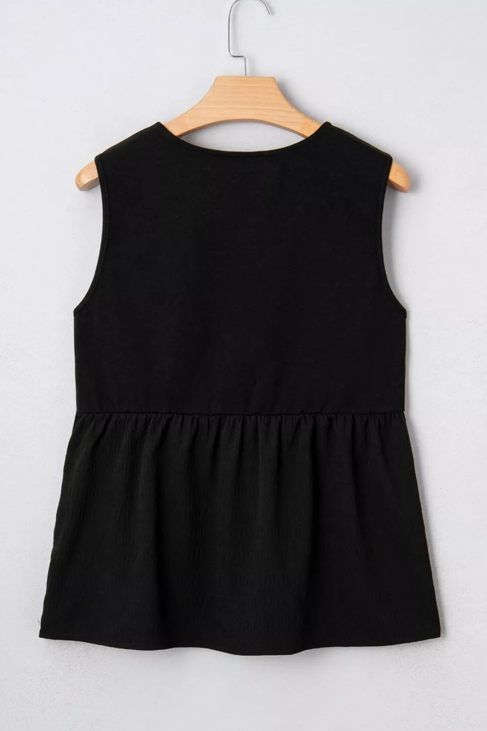 Full length view of the floral embroidered sleeveless top