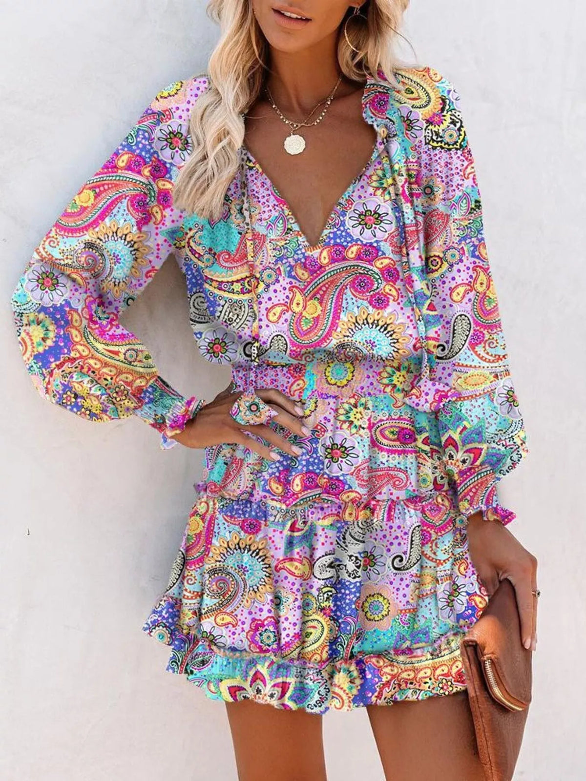 Tie neck lantern sleeve tiered dress close up view