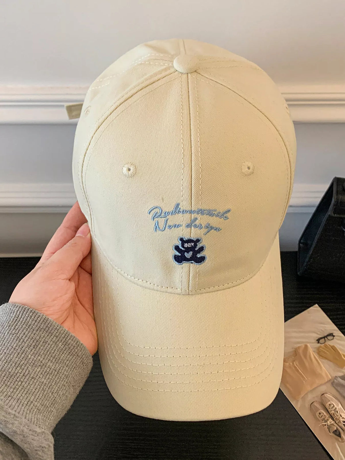 Embroidery detail on the front panel of the cotton cap
