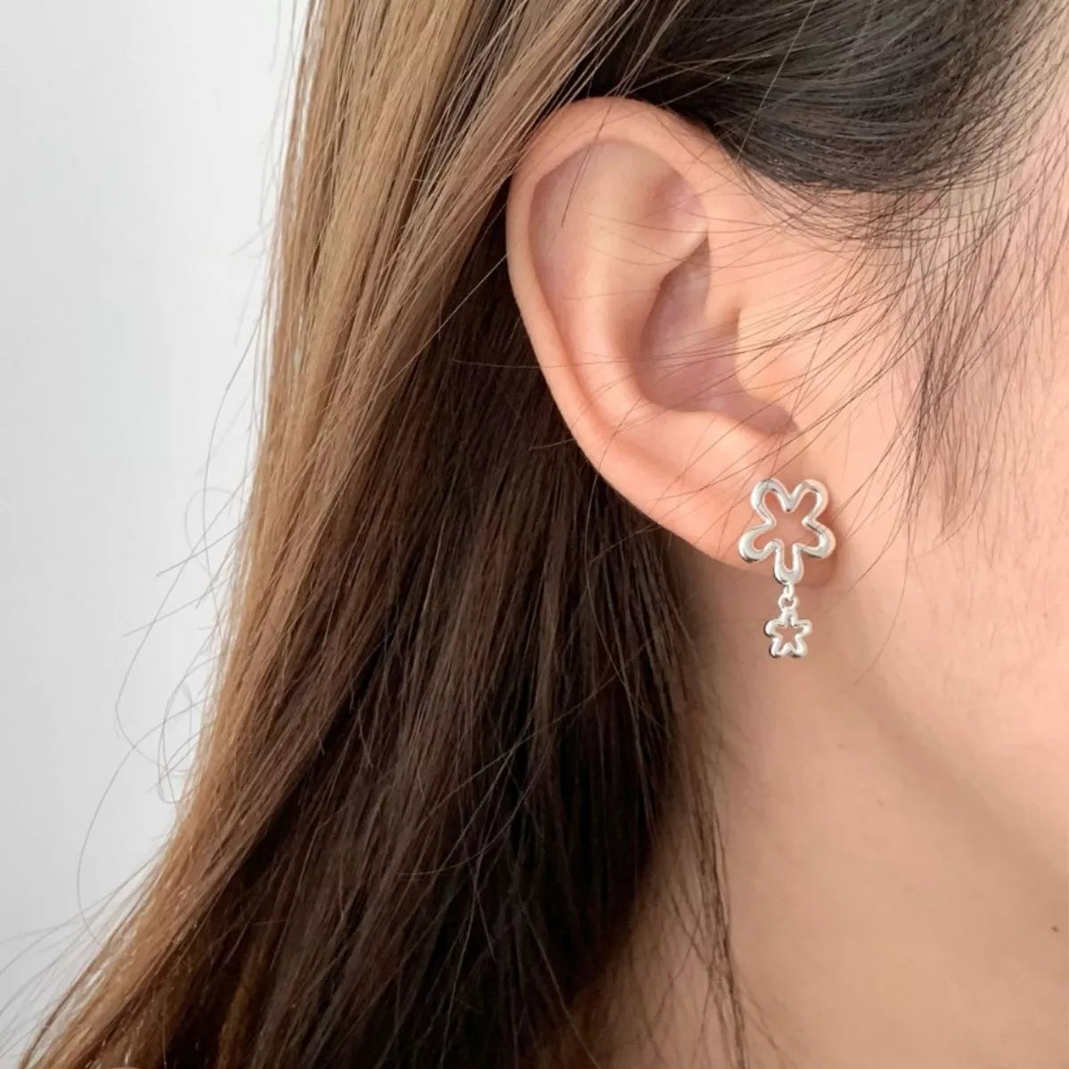 Close up of the silver flower petal detail on the drop earring