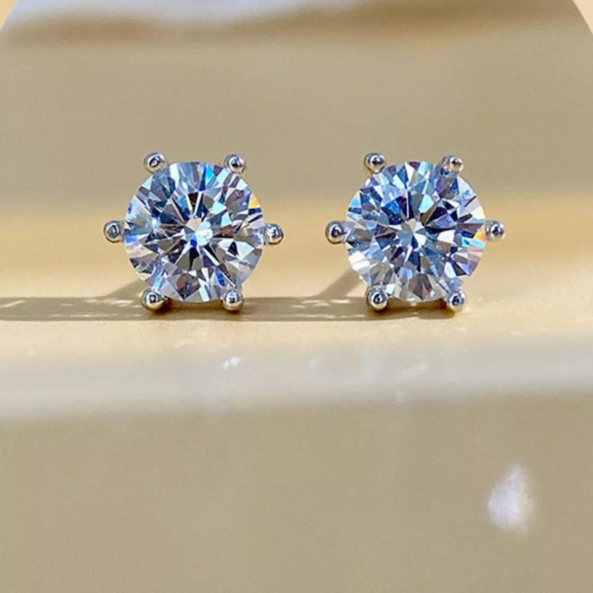 Stud earrings photographed with their matching box