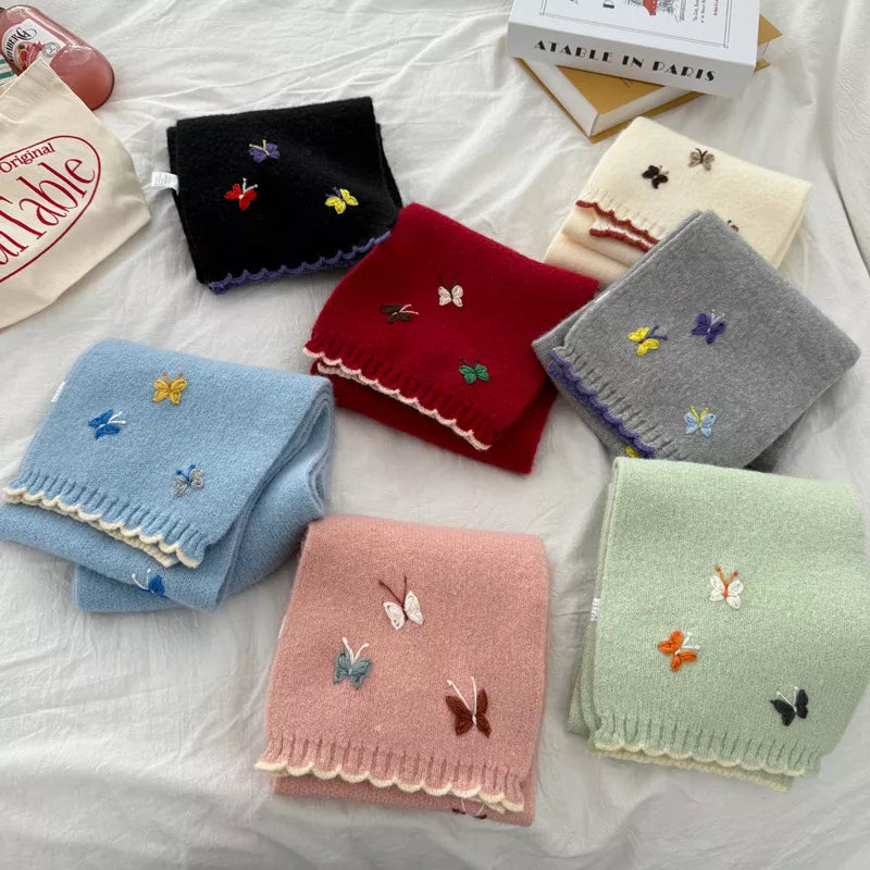Butterfly embroidered knitted scarf shown around the neck