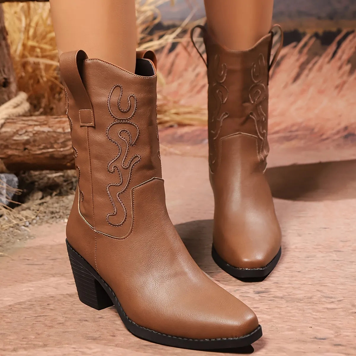 Pointed toe block heel boots pair styled together