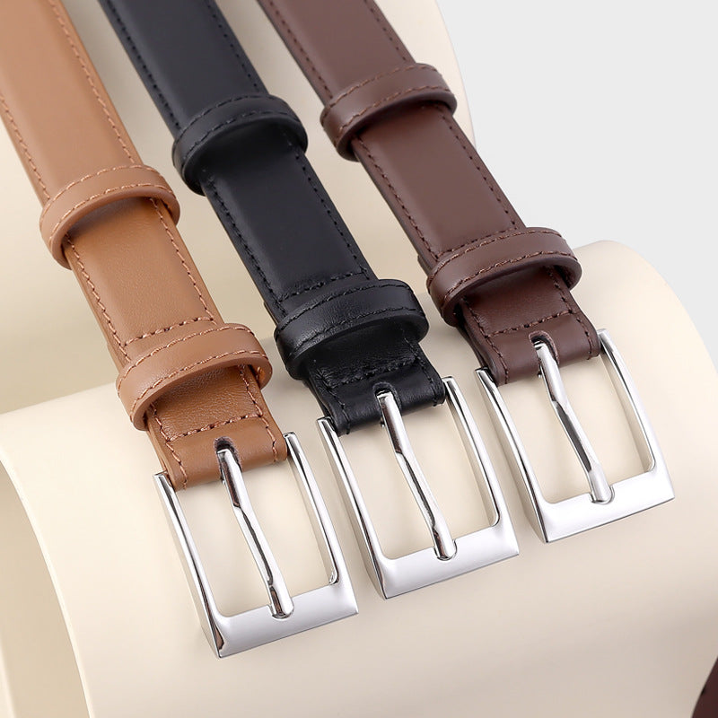 Classic skinny leather belt with silver buckle coiled