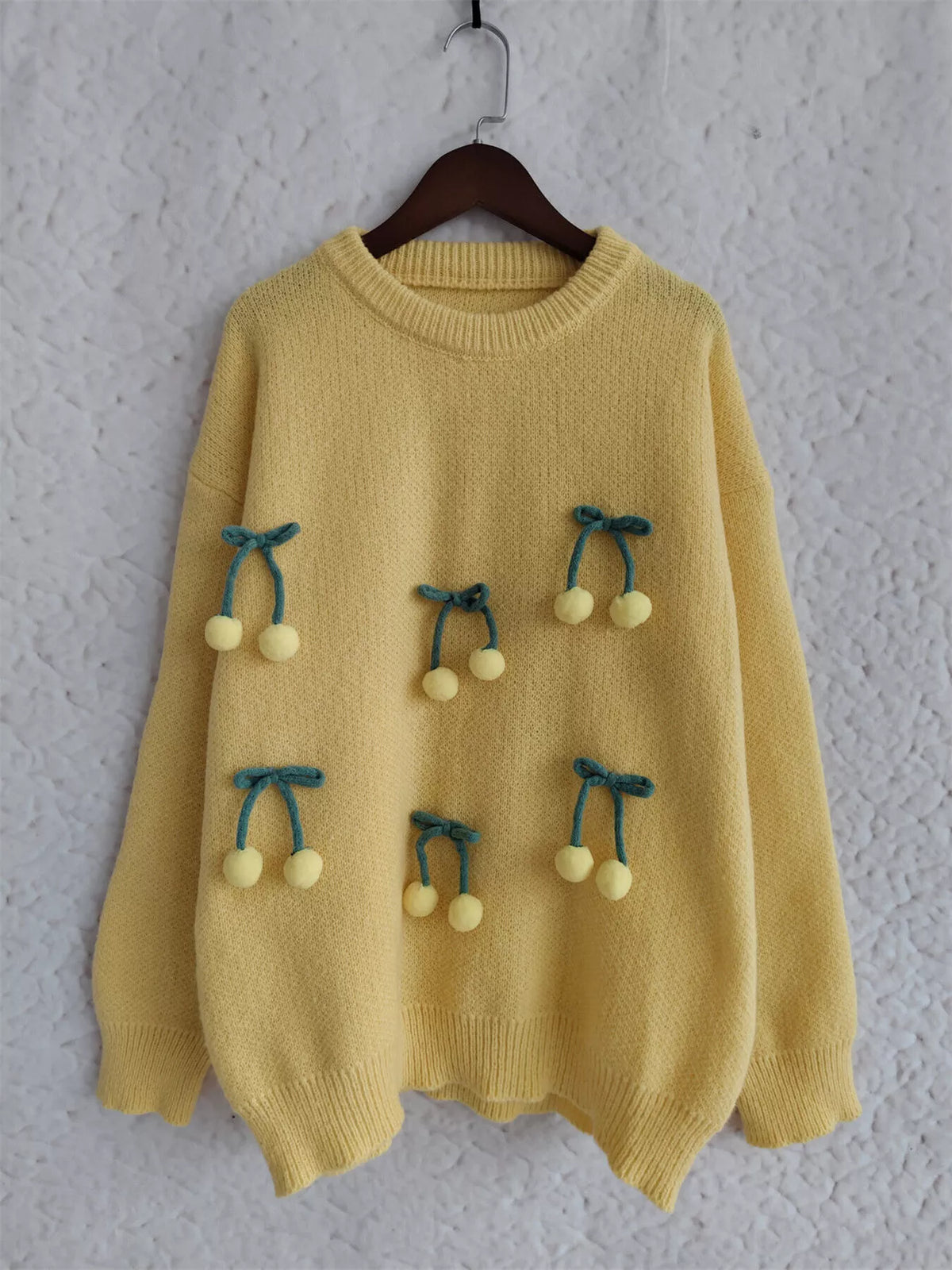 cherry pom pom round neck knit sweater styling detail