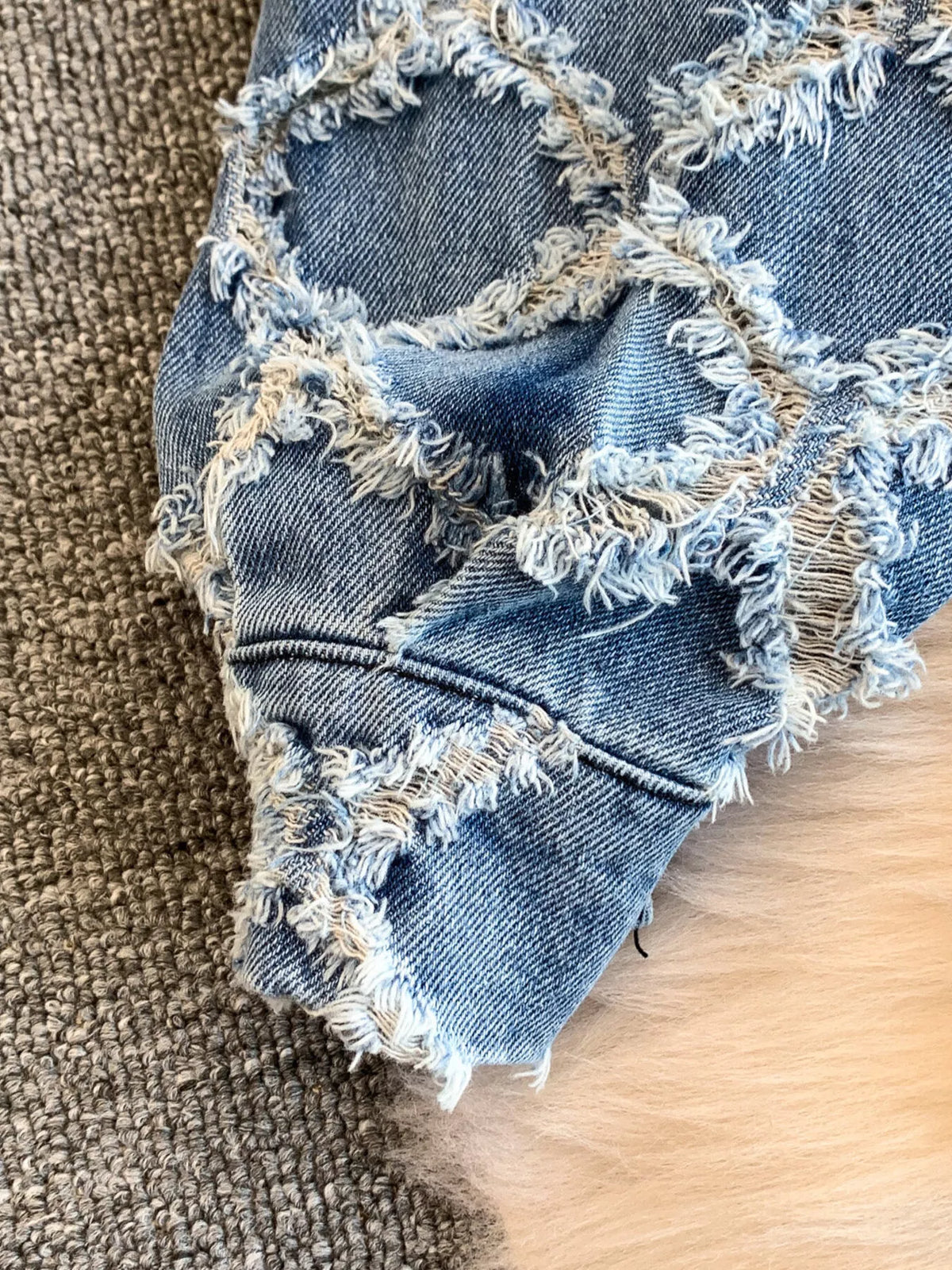 Distressed denim shorts close up