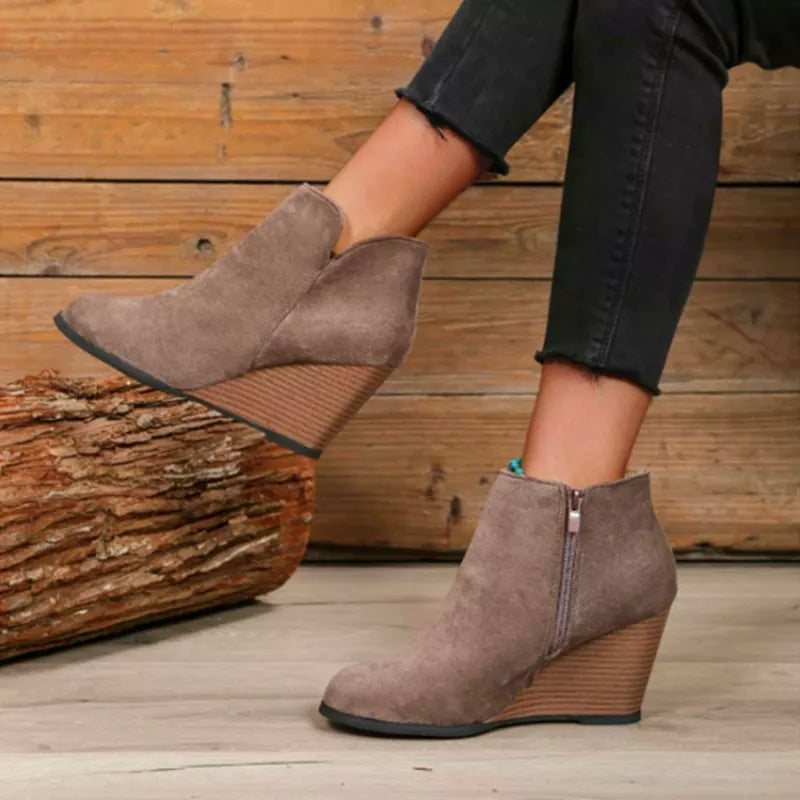 Round toe wedge ankle boots paired with denim