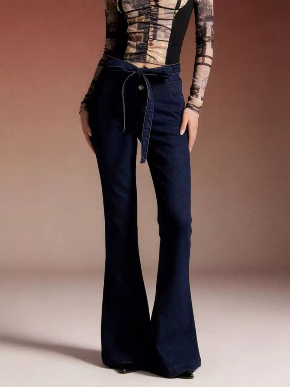 Flare jeans waistband tie close up