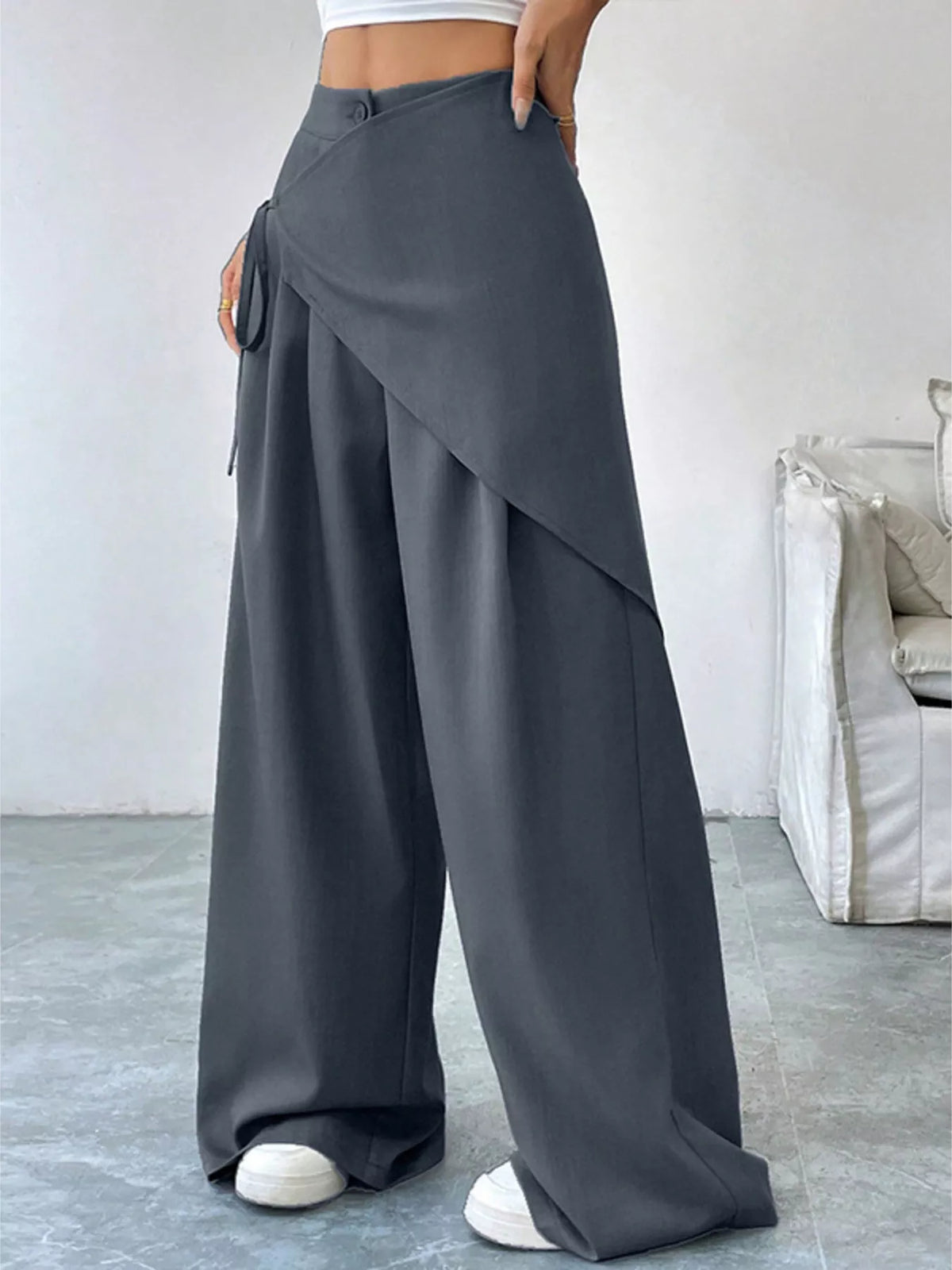 Side view of the gray wide leg pants showing the drape