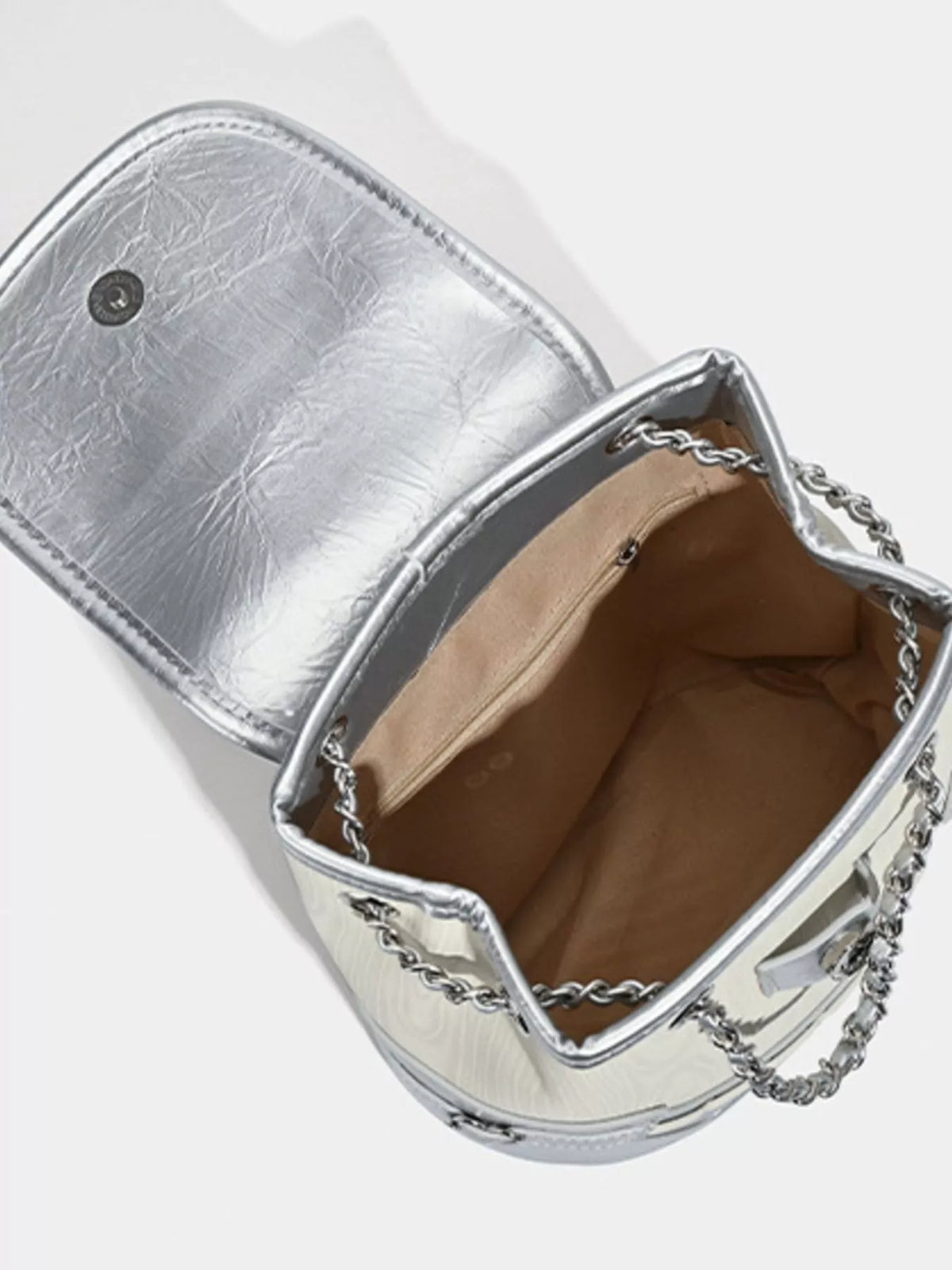 Heart flap mini backpack held in hand
