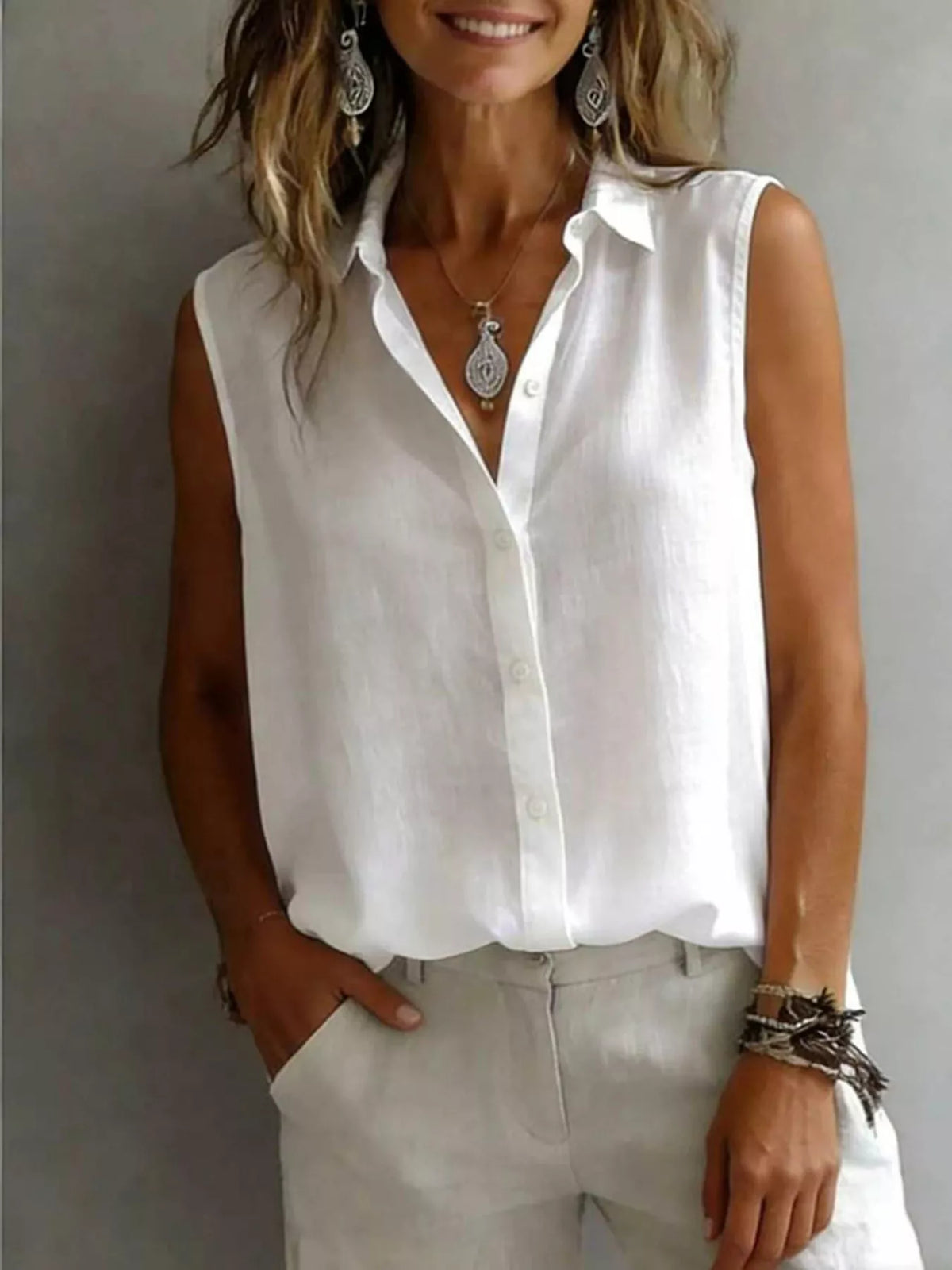 Sleeveless collared button down shirt detail view