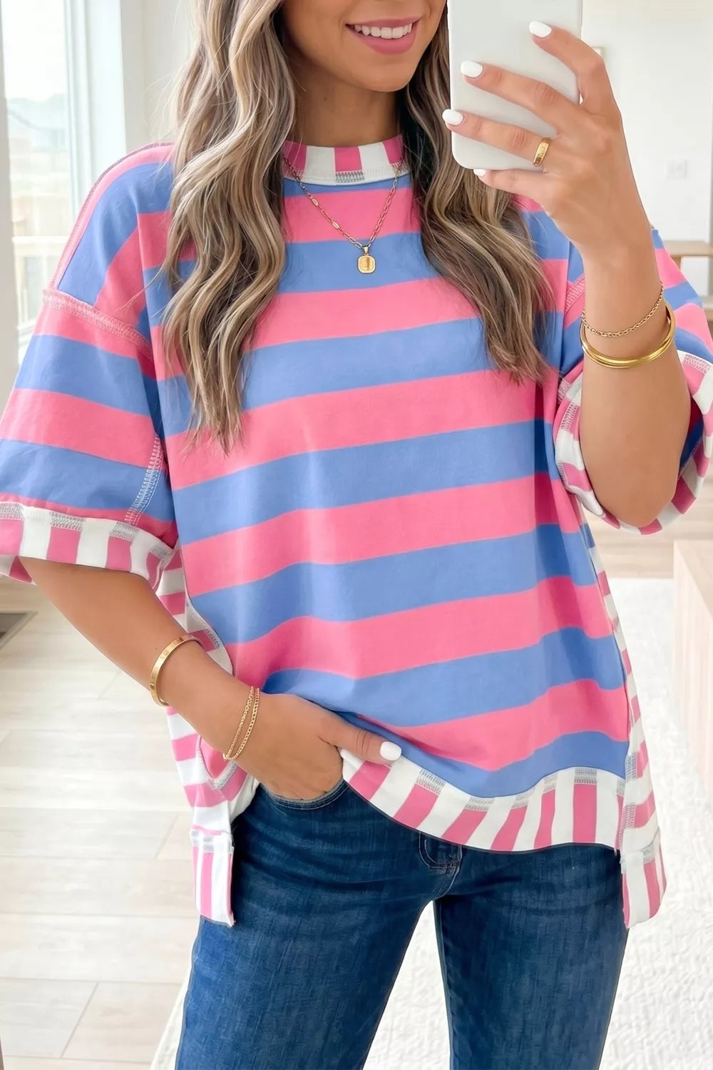 Fuchsia pink oversized striped top shown on model from the side
