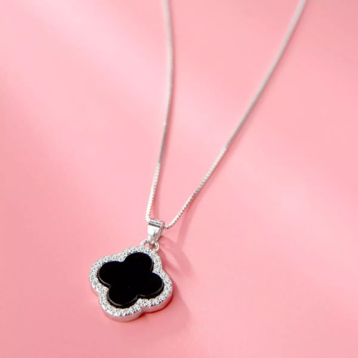 Clover necklace shown worn at the collarbone