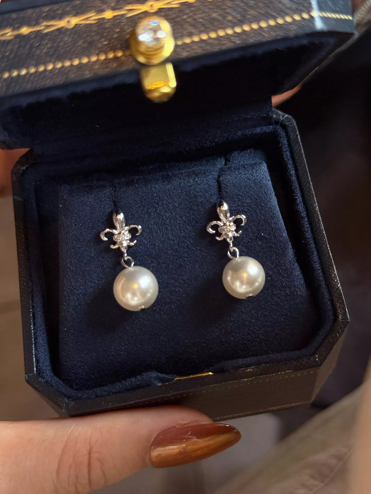 Pearl drop earrings styled on model