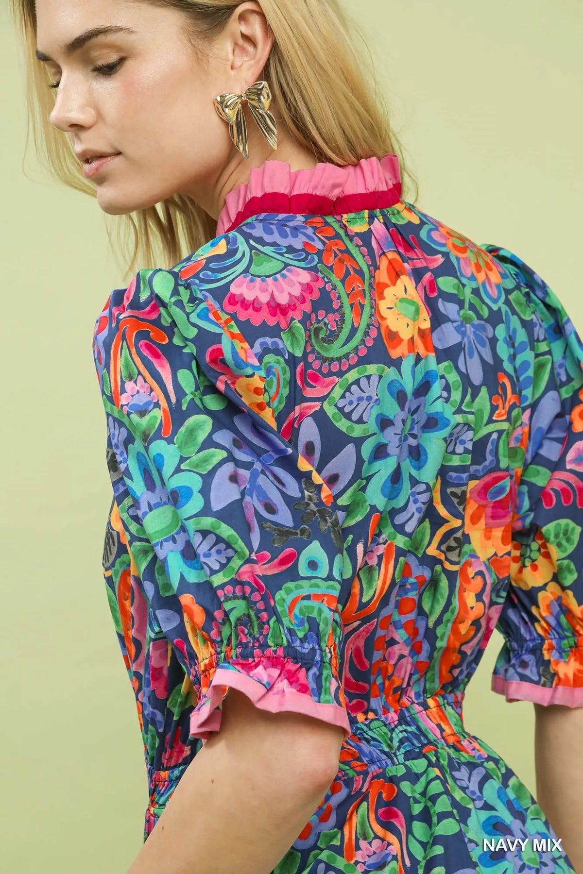 Side view of the floral midi dress showing the smocked waist and full skirt